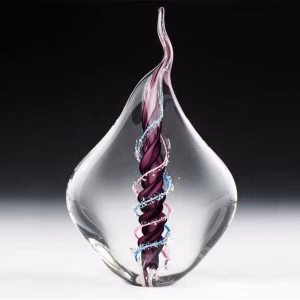 Dual flame glass memorial sculpture with cremation ash, featuring a clear teardrop form encasing intertwined purple, blue, and pink glass flames symbolizing eternal connection and remembrance.