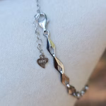 Close-up of the clasp and extension chain of the Sands of Time Infinity Cremation Bracelet in blue silver crinkle, showing sterling silver links, lobster clasp, and 925 heart tag on a white jewelry display.