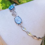 Triple Stone Cremation Bracelet featuring blue memorial glass stones in sterling silver settings