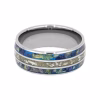 Cremation ring with ashes and flower petal inlay set in polished titanium memorial band, top view
