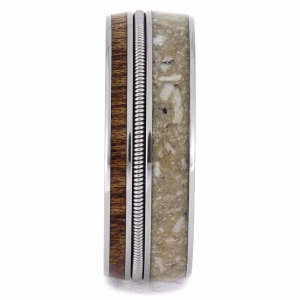 Side profile of cremation ring with ashes featuring guitar string detail, mahogany wood inlay, and titanium memorial band