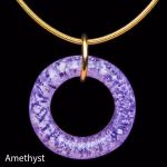 Amethyst halo cremation pendant with encased cremation ash on gold necklace displayed on black background