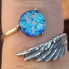 Angel Wing Cremation Ring made with cremation ash set in a sterling silver wing band with blue memorial glass jewel