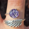 Angel Wing Cremation Ring made with cremation ash set in a sterling silver wing band with purple memorial glass jewel