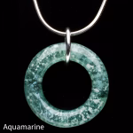 Halo Cremation Pendant in aquamarine, featuring a translucent blue-green glass ring with soft white ash inclusions, suspended from a silver chain against a black background.