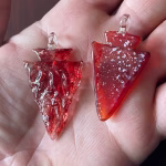 Arrowhead cremation pendants showing smooth and textured finish comparison.