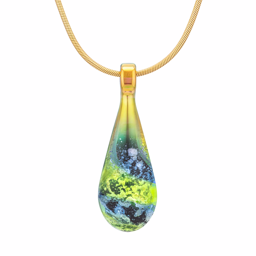 Handcrafted spiral teardrop cremation pendant made with cremation ash, featuring layered black opal, emerald green, and golden tones in memorial glass, suspended from a gold-toned chain.