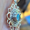 Side view of Mandala Flower cremation pendant with blue silver crinkle glass memorial stone in sterling silver
