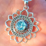 Close up of Mandala Flower cremation pendant with blue silver crinkle glass memorial stone in sterling silver
