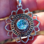 Front view of Mandala Flower cremation pendant with blue silver crinkle glass memorial stone in sterling silver