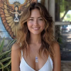 Model wearing a Boho Feather Cremation Pendant necklace, featuring a silver feather memorial pendant with blue cremation ash glass inlay, styled in a natural outdoor setting
