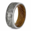 Meteorite cremation ring with ashes and whisky barrel oak interior memorial ring angled view