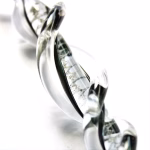 Icicle Ornament with Cremation Ash in clear glass with black interior accent, shown in close-up detail on a white background studio setting