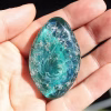 Elongated Galaxy cremation stone made with memorial glass featuring swirling blue and green tones