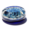 Side view of round Galaxy cremation stone made with blue memorial glass featuring swirling galaxy pattern