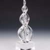 Hand-blown glass Legacy Flame cremation sculpture in black and white, featuring elegant swirling monochrome ribbons encased in clear glass and displayed on a polished square glass base as a timeless memorial keepsake.