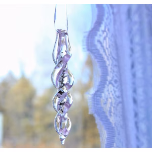 Icicle Ornament with Cremation Ash in clear glass with soft purple interior swirl, hanging near a window in natural light with outdoor background