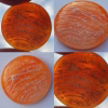 Orange Cloud Cremation Stone Set glass stone with cremation ash shown in multiple lighting conditions