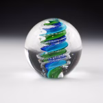 Handcrafted Eternity Sphere memorial made with cremation ash, featuring a flowing blue and green spiral encased in clear glass with fine ash inclusions suspended along the curves.
