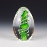 Handmade green eternity egg memorial with cremation ash.