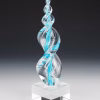 Aqua Legacy Flame cremation ash sculpture featuring hand-blown clear glass with swirling aqua blue accents, created as an elegant memorial art glass keepsake displayed on a polished glass base.