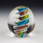 Handcrafted Eternity Sphere memorial made with cremation ash, featuring a flowing multicolor spiral encased in clear glass with delicate ash inclusions suspended throughout.