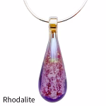 Teardrop cremation pendant with rhodalite purple glass, encased cremation ash, displayed on a silver chain against a white background