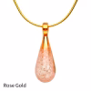Teardrop cremation pendant in Rose Gold glass with cremation ash encased inside, shown on a gold-tone chain.