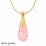Teardrop cremation pendant in Rose Quartz glass with cremation ash encased inside, shown on a gold-tone chain.