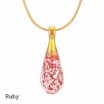 Teardrop cremation pendant in Ruby glass with cremation ash encased inside, shown on a gold-tone chain.