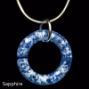 Halo Cremation Pendant in sapphire blue glass, shown on a silver chain against a black background.