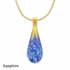 Teardrop cremation pendant in Sapphire glass with cremation ash encased inside, shown on a gold-tone chain.