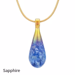 Teardrop cremation pendant in Sapphire glass with cremation ash encased inside, shown on a gold-tone chain.