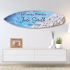 Oceanside Memorial Surfboard with cremation ash, featuring ocean blue and white wave design with seashell details and personalized memorial text, displayed horizontally mounted on a living room wall above a modern console