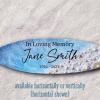 Oceanside Memorial Surfboard with cremation ash, featuring ocean blue and white wave design with seashell details and personalized memorial text, shown horizontally against a neutral background
