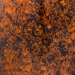 Close-up of tall bamboo cremation urn in amber showing textured lacquer finish