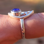 Side profile of a Family Tree cremation ring in sterling silver, showing the raised round sparkling blue memorial glass setting containing cremation ash.