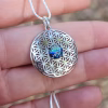 Boho Flower cremation pendant with iridescent memorial glass centerpiece set in a sterling silver flower-of-life design.