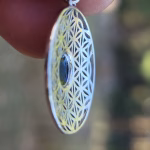 Side view of Boho Flower cremation pendant with iridescent glass memorial stone in sterling silver.