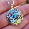 Front view of Boho Flower cremation pendant with iridescent glass memorial stone in sterling silver.