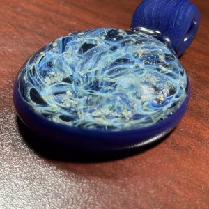 Handmade dark blue galaxy cremation pendant made with cremation ash.