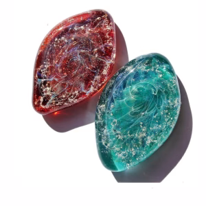 Galaxy cremation stones in red and green memorial glass shown together