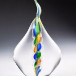 Handmade memorial flame made with cremation ash in blue, green, and gold.