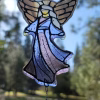 Handcrafted Guardian Angel suncatcher made with cremation ash, featuring stained glass angel wings and flowing robes with a hanging crystal accent, designed to catch and reflect natural light.