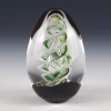 Handcrafted spiral egg-shaped cremation glass keepsake featuring a clear glass form with a green spiral design and suspended cremation ashes inside.