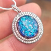 Halo Cremation Pendant with Cubic Zirconia in sterling silver, featuring a blue memorial ash inlay held on a silver chain