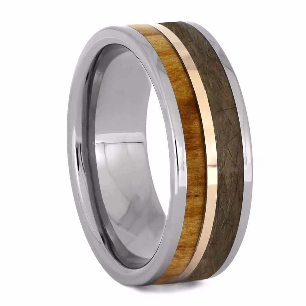 Angled view of tungsten memorial ring with rowan wood inlay, rose gold center channel, and preserved pet fur on white background