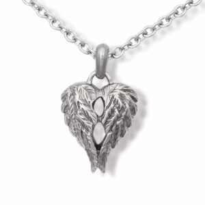 Close-up image of a silver heart-shaped cremation pendant formed by detailed angel wings, shown on a silver chain against a white background.