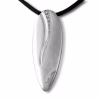 Polished silver cremation pendant with an elongated teardrop shape, featuring a flowing engraved curve accented by a row of small sparkling diamonds, shown hanging from a black cord.