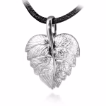 Silver cremation pendant shaped like a detailed leaf, featuring textured veins and a polished central stem, shown suspended from a black cord.